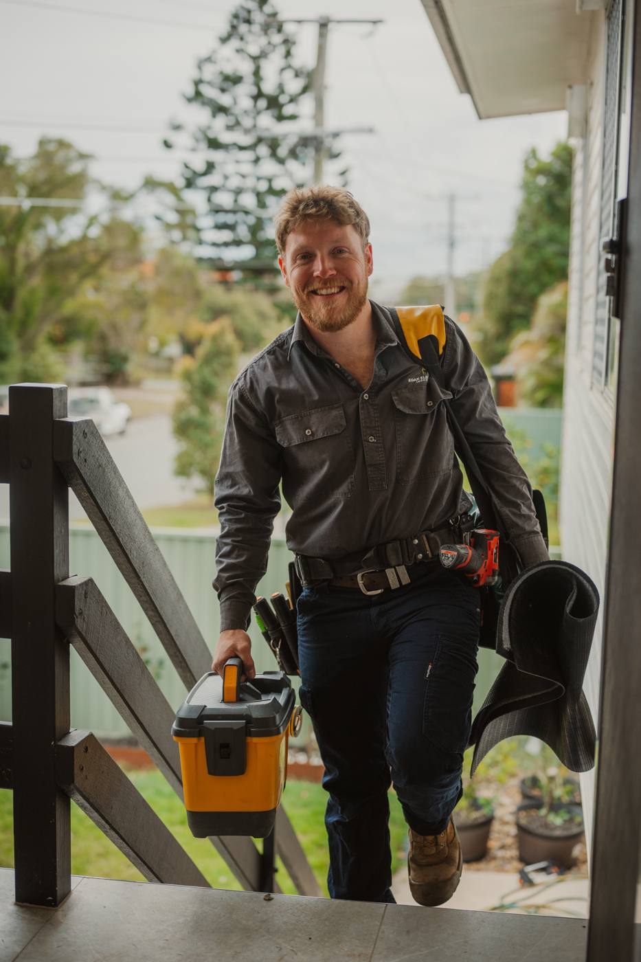 Egan Electrical electrician arriving at a job with his toolbox