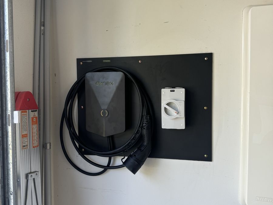 Wall-mounted EV charger with isolator in a garage