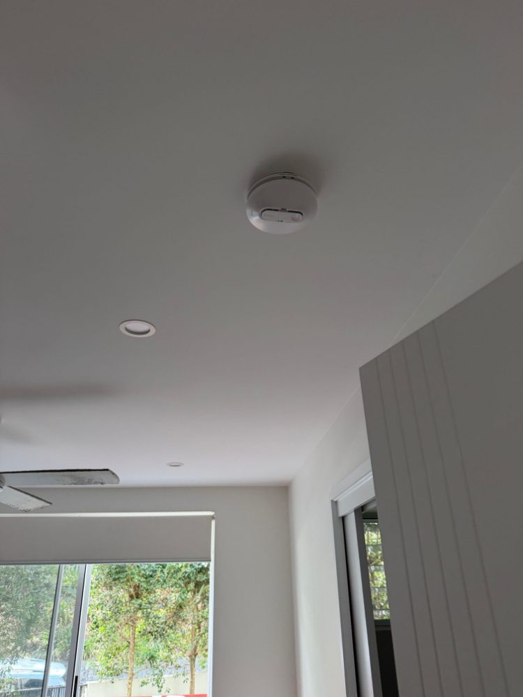 Interconnected photoelectric smoke alarm on a living room ceiling