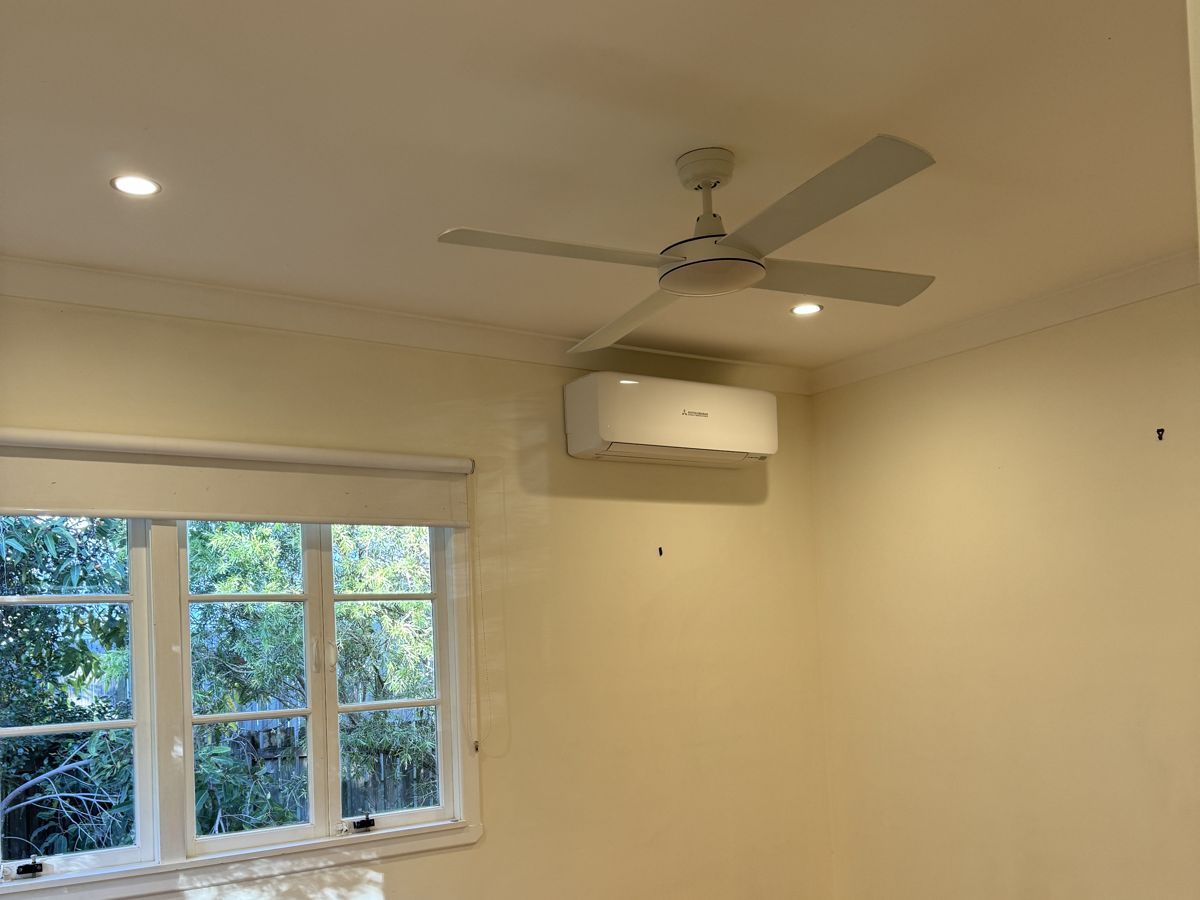 Split system air conditioner and ceiling fan in a renovated bedroom