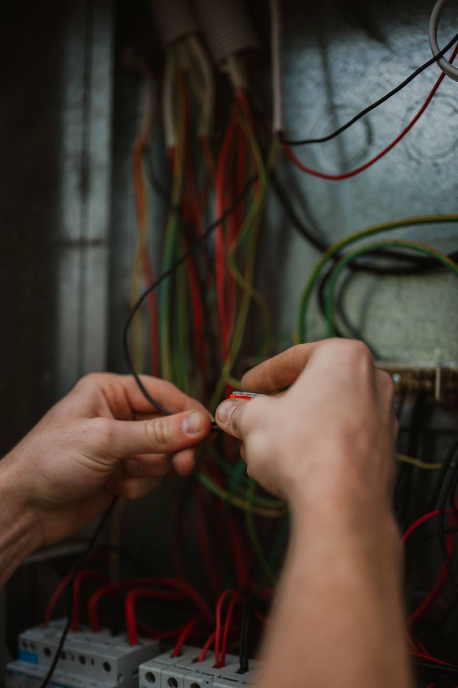 Close-up of hands terminating wiring